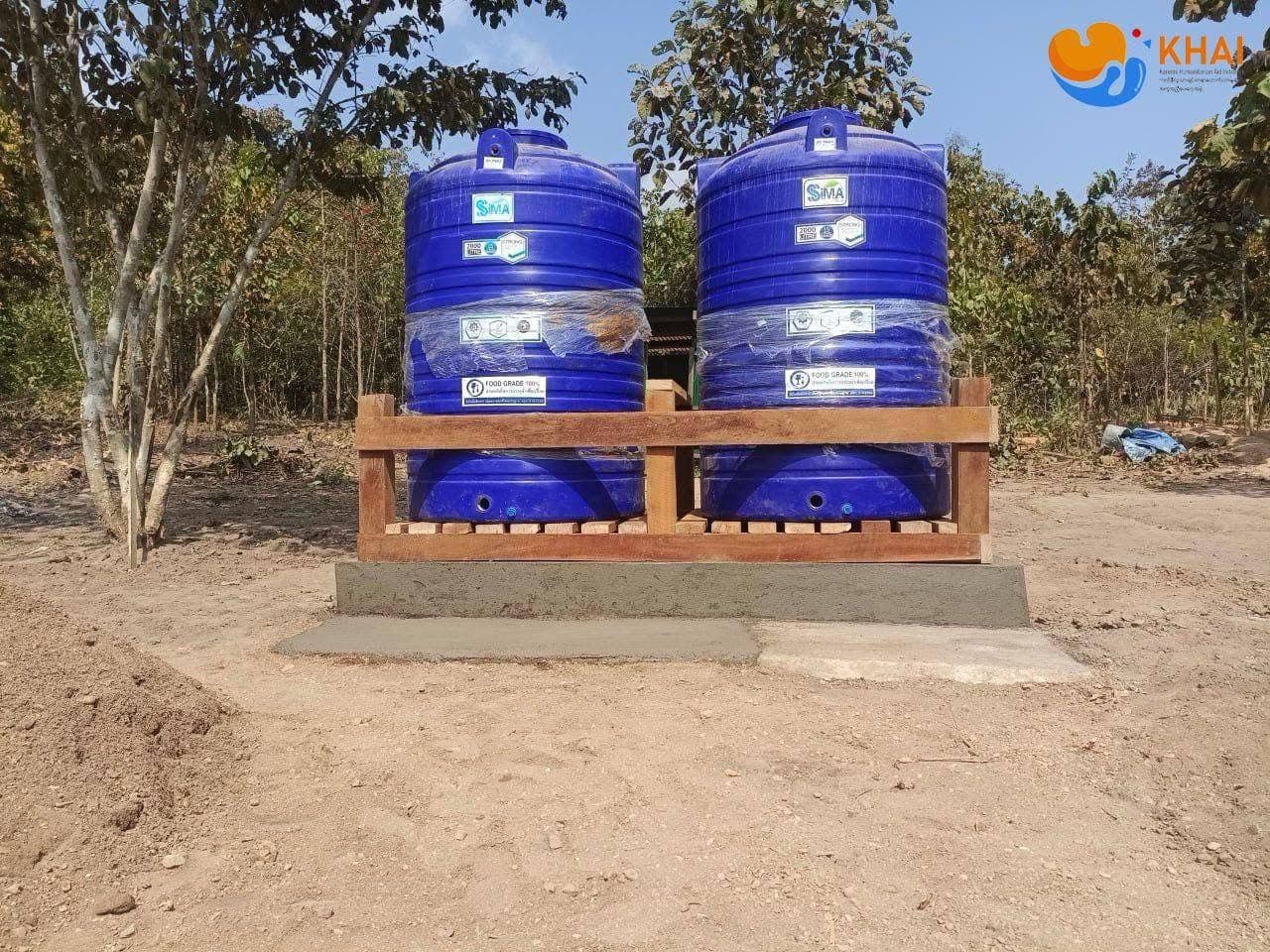 Community members gathered around a completed well
